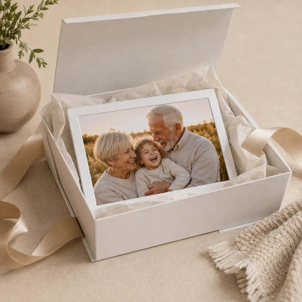 Pintura cordless digital photo frame displayed in an open gift box with a warm family photo on the screen.