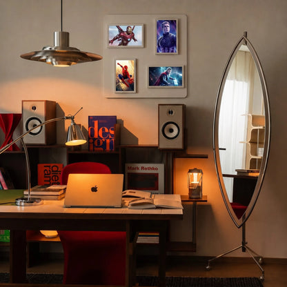 Pintura digital frames displaying Marvel superhero art on a wall in a modern home office setup.
